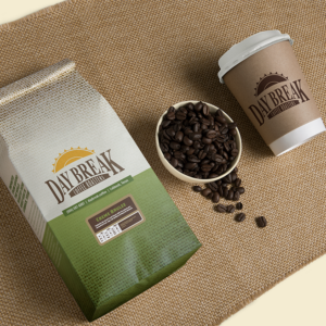 Day Break Creme Brulee Coffee bag, beans, and coffee cup